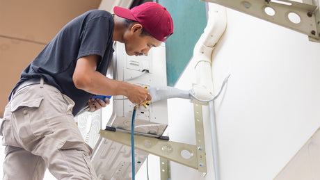 professional-aircon-staff-checking-aircon-pipe-mang-kosme